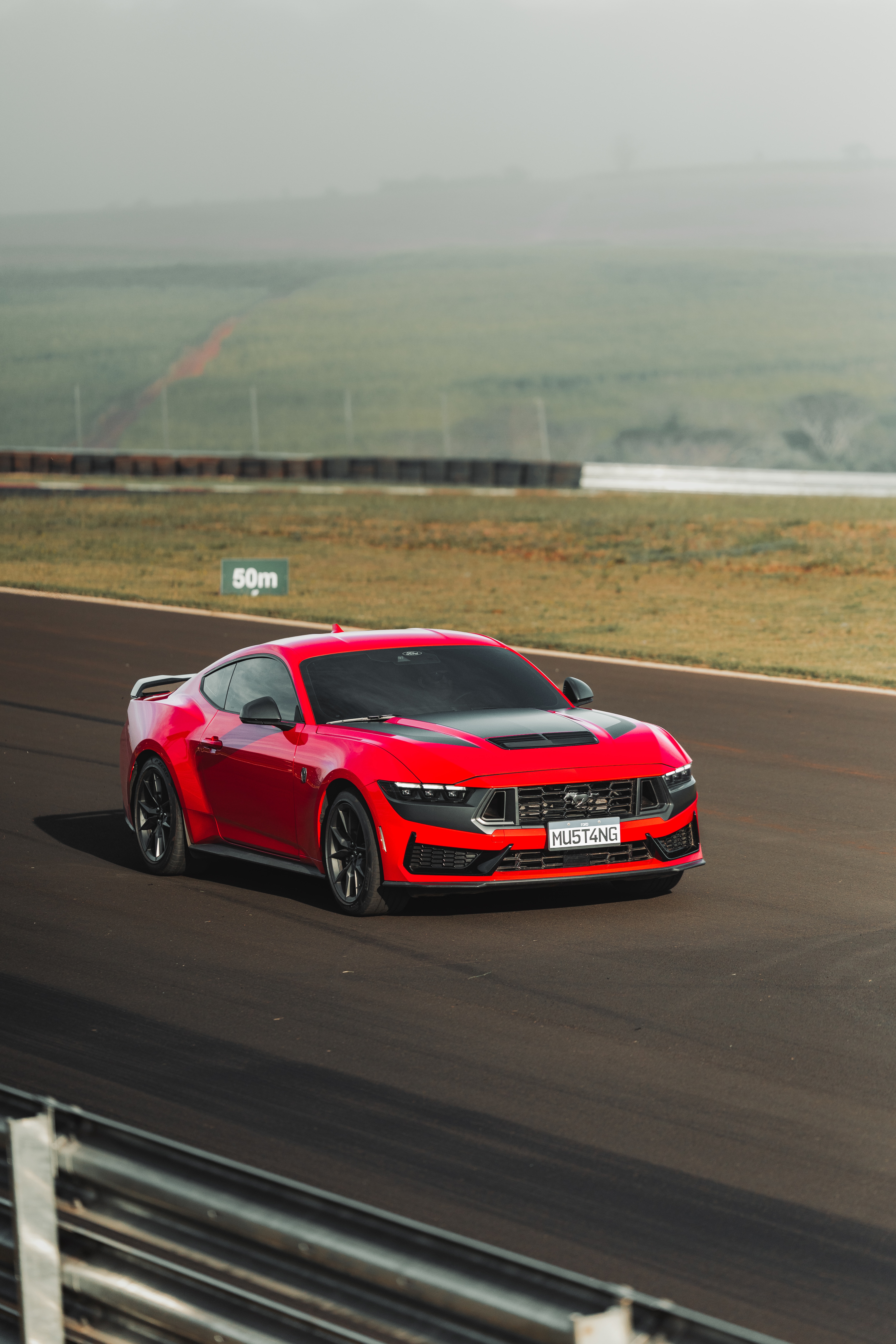Ford Mustang Dark Horse vermelho rodando em uma pista